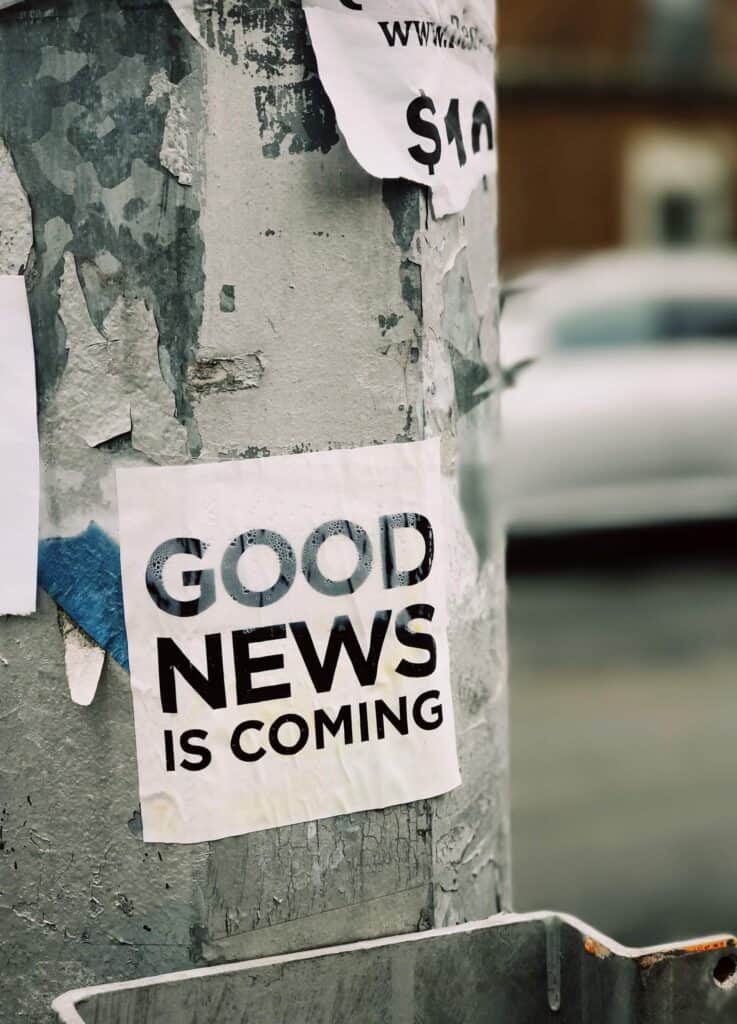 street pole with poster display 'good news is coming