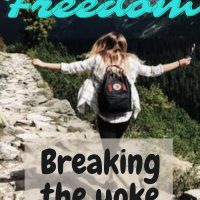 girl with backpack walking freely on a mountain